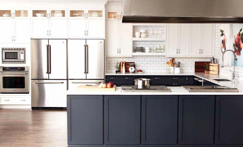 A modern kitchen with white cabinets and two refrigerators